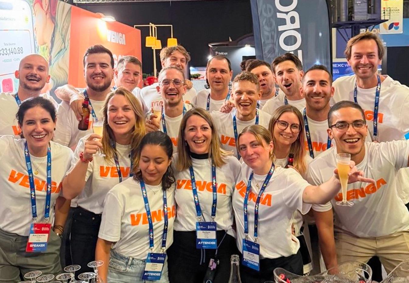 Venga team celebration with banner